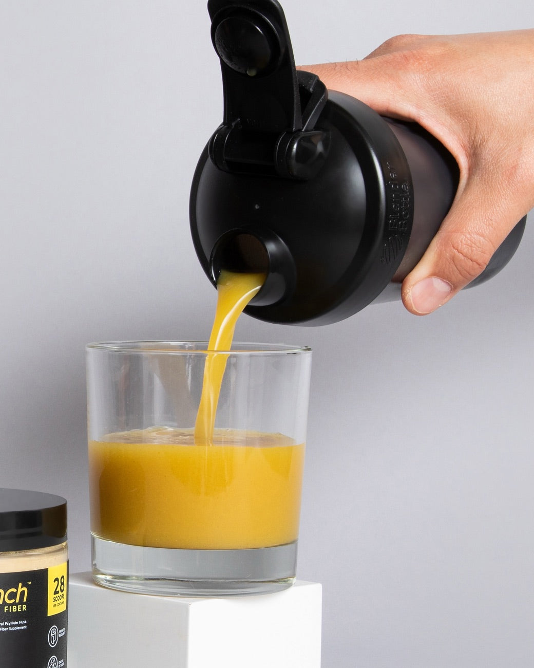 Pinch Lemon Ginger being poured from a shaker bottle into a glass, mixing smooth with no grit or sediment