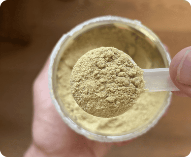 Customer holding a scoop of Pinch psyllium powder